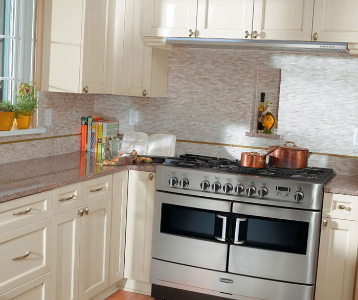 Off white cabinets in casual kitchen by Kitchen Craft Cabinetry