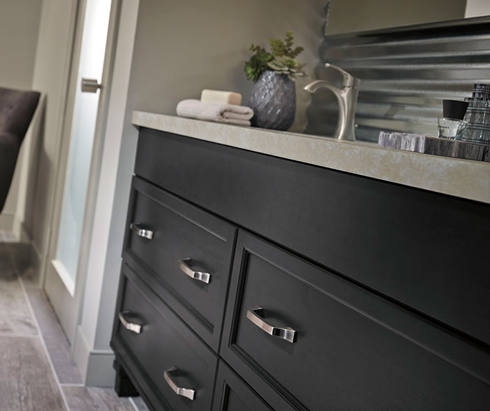 Dark gray cabinets in a casual bathroom by Kitchen Craft Cabinetry